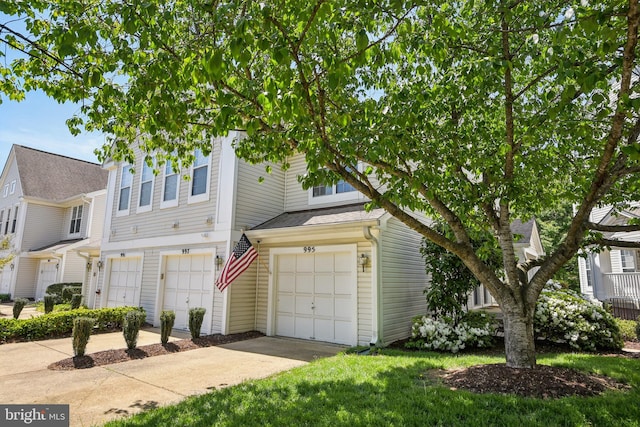 view of property featuring an attached garage and driveway