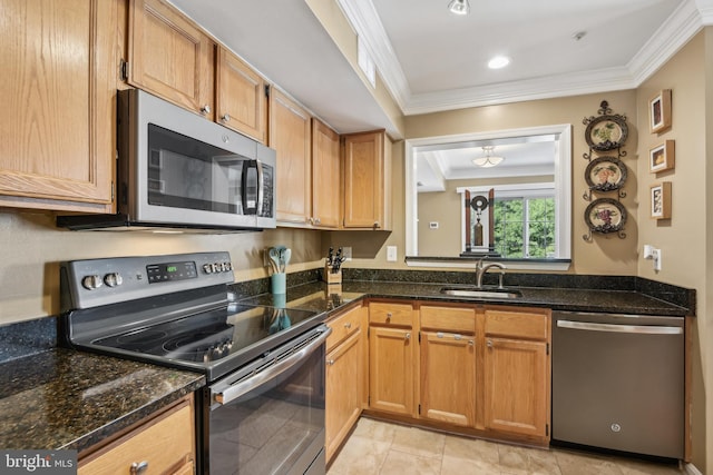 kitchen featuring a sink, appliances with stainless steel finishes, ornamental molding, and dark stone counters