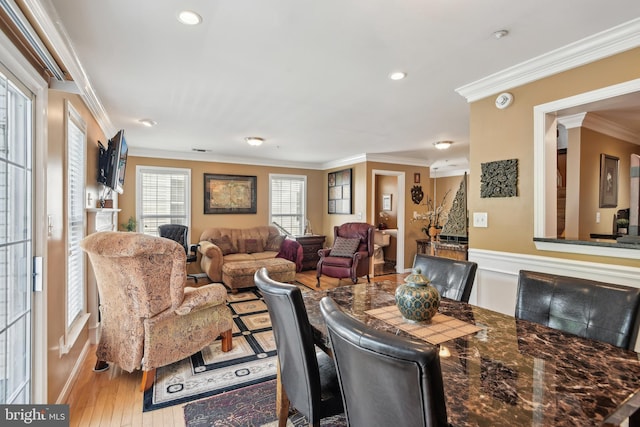 dining space with crown molding, recessed lighting, baseboards, and wood finished floors