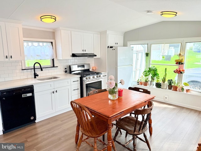 38 Clara St, Norristown, PA 19403 - kitchen with black dishwasher, gas range, freestanding refrigerator, under cabinet range hood, and light wood-style floors