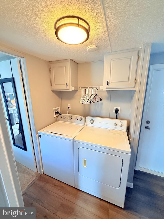38 Clara St, Norristown, PA 19403 - washroom with cabinet space, independent washer and dryer, wood finished floors, and a textured ceiling