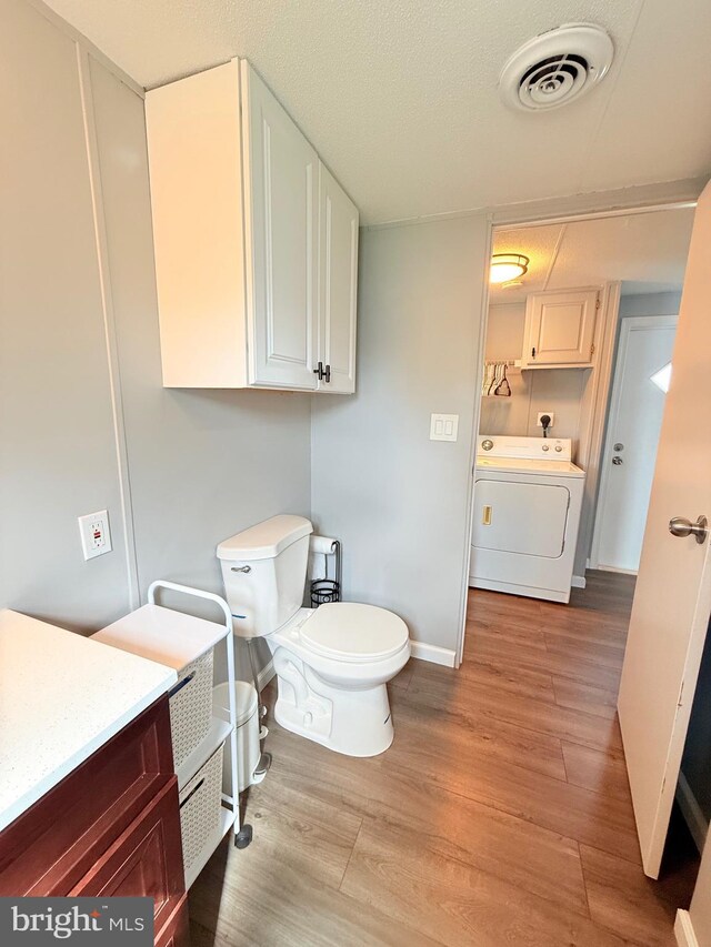 38 Clara St, Norristown, PA 19403 - bathroom featuring washer / clothes dryer, wood finished floors, and vanity