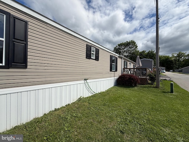 38 Clara St, Norristown, PA 19403 - view of side of property featuring a lawn and a wooden deck