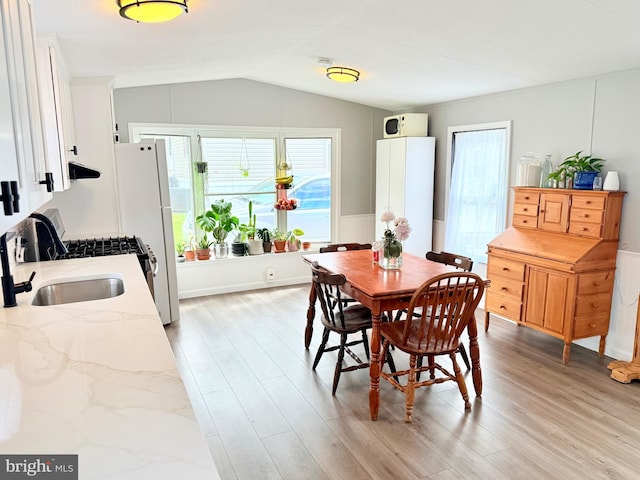 38 Clara St, Norristown, PA 19403 - dining room with light wood-style floors, lofted ceiling, and wainscoting
