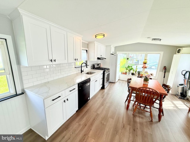 38 Clara St, Norristown, PA 19403 - kitchen with dishwasher, stainless steel gas stove, light wood-type flooring, lofted ceiling, and plenty of natural light