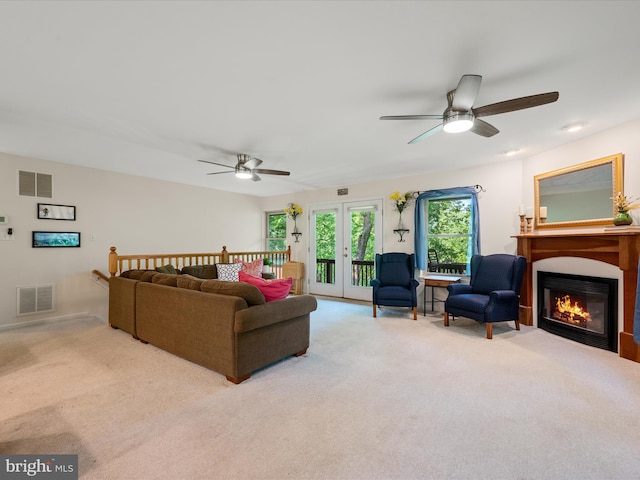 173 Riverside Dr, Harpers Ferry, WV 25425 - carpeted living room featuring a ceiling fan, a fireplace with flush hearth, and french doors
