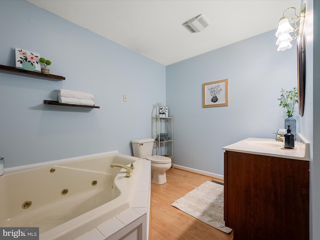 173 Riverside Dr, Harpers Ferry, WV 25425 - full bathroom featuring toilet, a whirlpool tub, vanity, wood finished floors, and baseboards