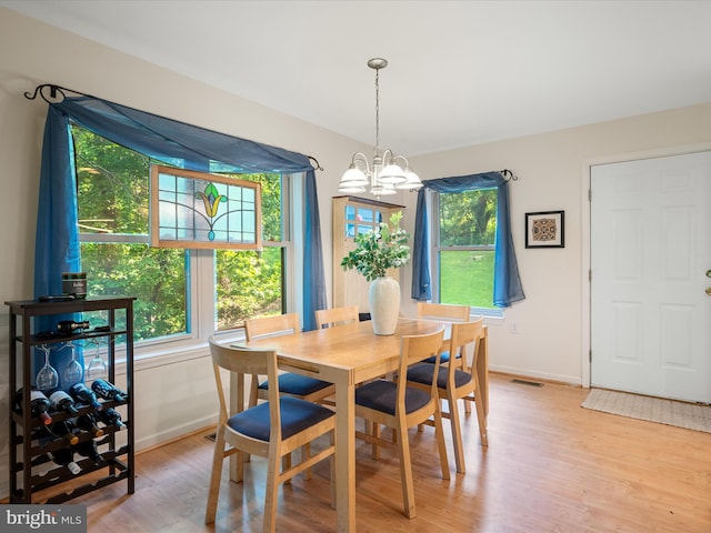 173 Riverside Dr, Harpers Ferry, WV 25425 - dining space with baseboards, light wood-style flooring, and a chandelier