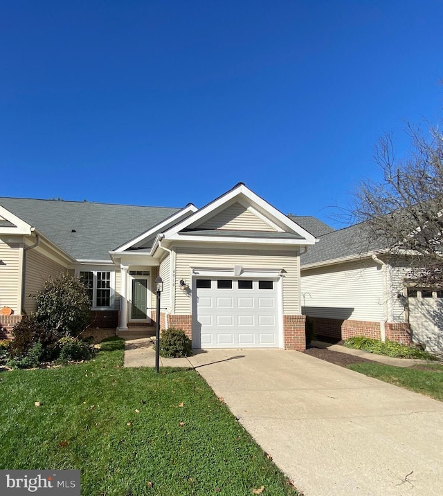 single story home with brick siding, driveway, a front lawn, and a garage