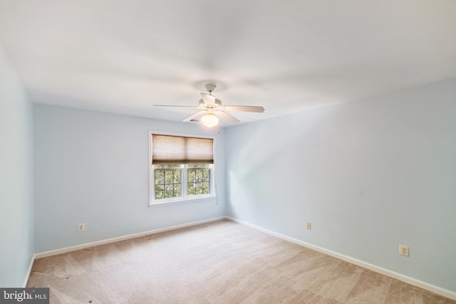 unfurnished room featuring baseboards, ceiling fan, and light colored carpet