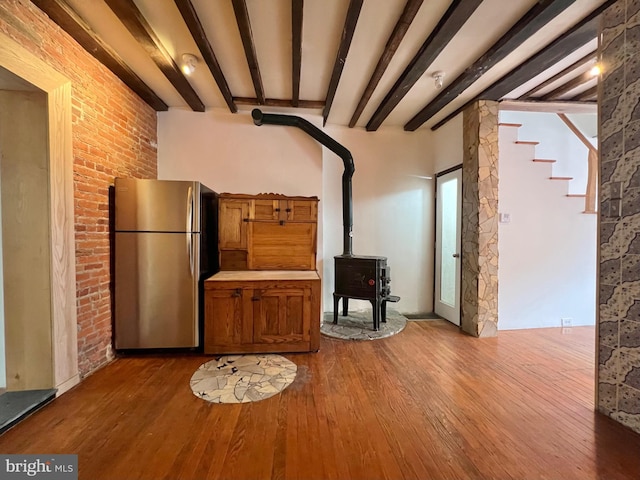2102 E Dauphin St, Philadelphia, PA 19125 - unfurnished living room featuring a wood stove, dark wood-style floors, and beam ceiling