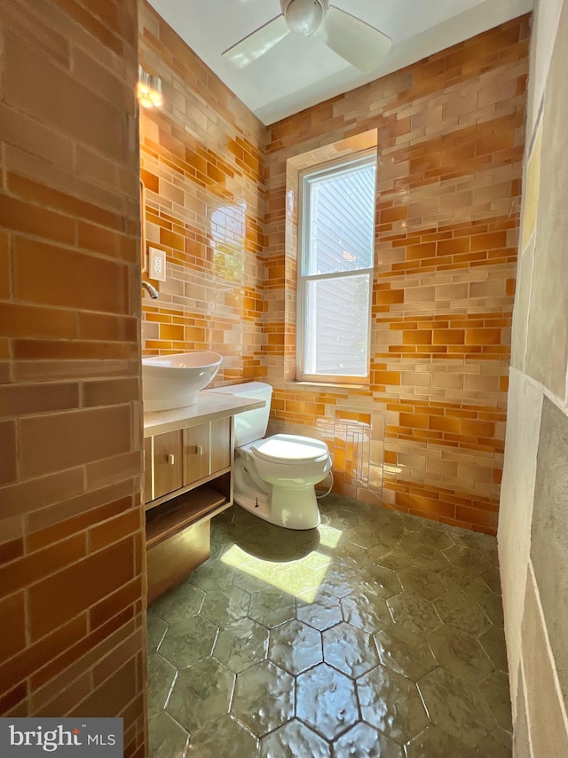 2102 E Dauphin St, Philadelphia, PA 19125 - half bath with stone flooring, a ceiling fan, toilet, and vanity