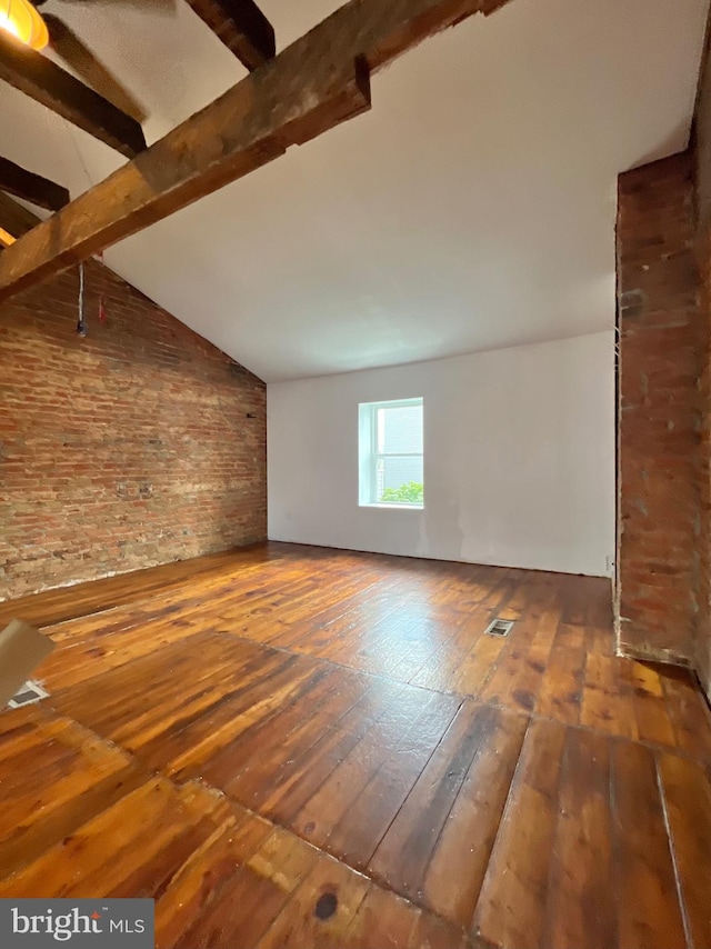 2102 E Dauphin St, Philadelphia, PA 19125 - unfurnished living room featuring wood-type flooring and brick wall