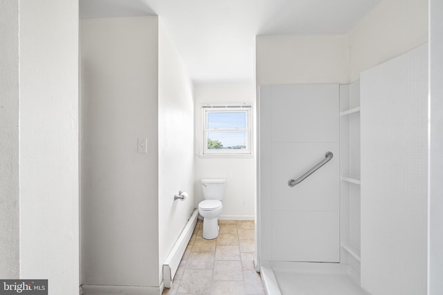 bathroom featuring toilet, baseboards, and baseboard heating