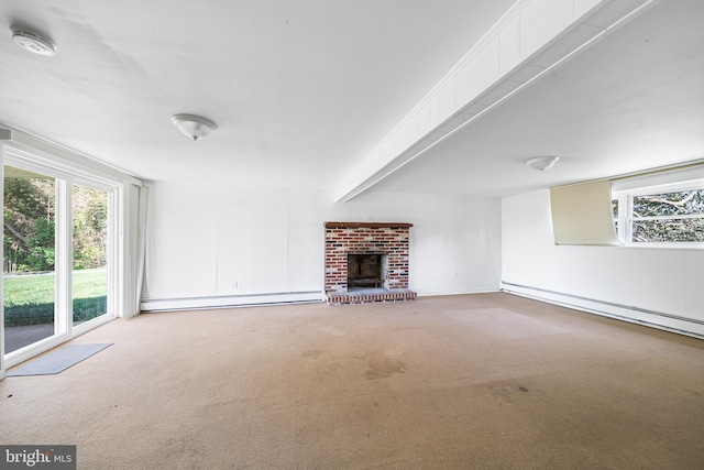 unfurnished living room featuring carpet floors, a wealth of natural light, baseboard heating, and a fireplace