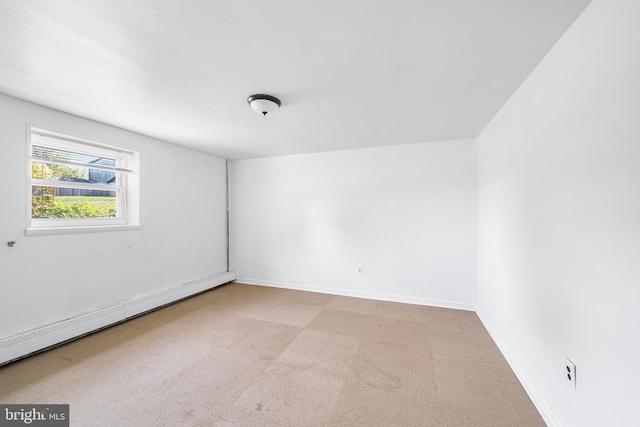 carpeted empty room featuring baseboards and baseboard heating