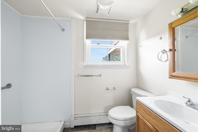 bathroom with vanity, baseboards, and toilet