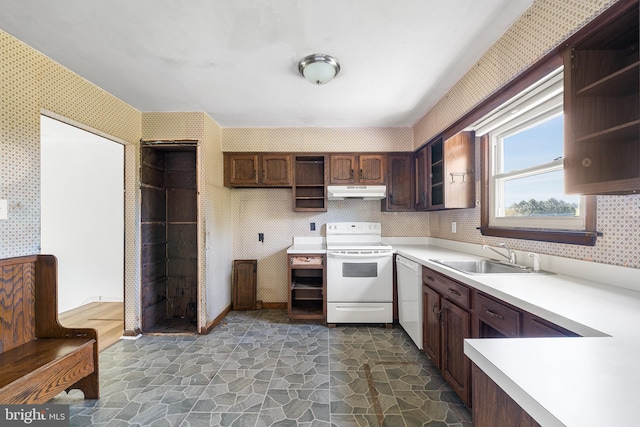 kitchen featuring a sink, open shelves, white appliances, and wallpapered walls