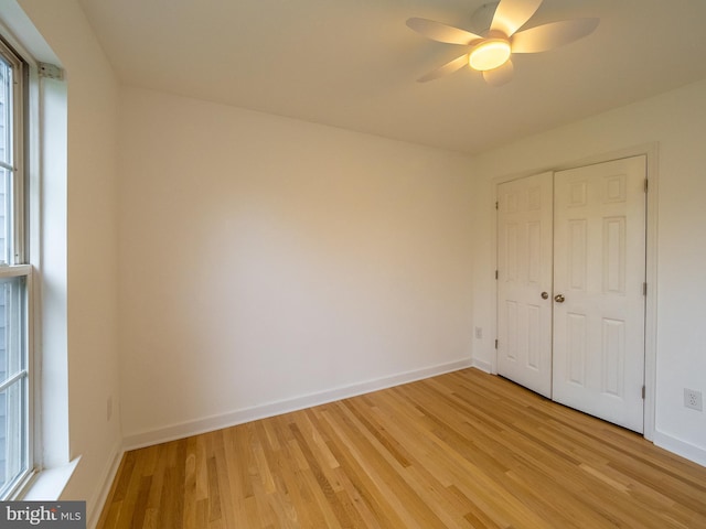 70 River Ln, Delanco, NJ 08075 - unfurnished bedroom with light wood-type flooring, baseboards, a closet, and a ceiling fan