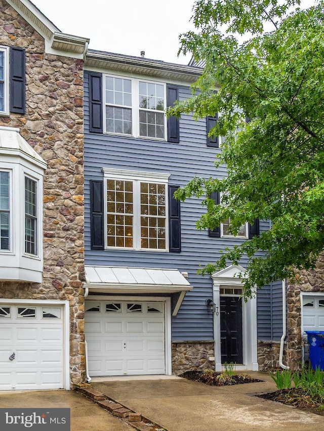 70 River Ln, Delanco, NJ 08075 - view of property with stone siding, an attached garage, and driveway