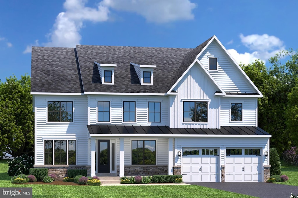 view of front of home with a standing seam roof, a shingled roof, metal roof, an attached garage, and driveway