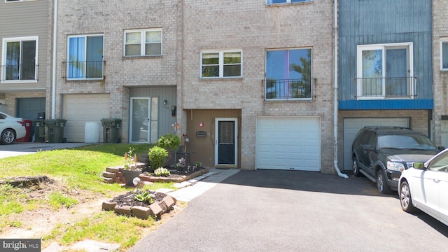 1806 Crest Dr, Coatesville, PA 19320 - townhome / multi-family property with brick siding, a garage, and driveway