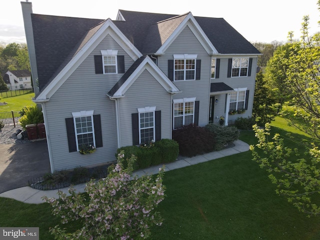 view of front of property with a chimney and a front yard