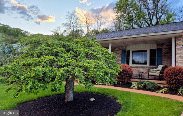 289 Cornfield Cir, Lewistown, PA 17044 - view of front of house featuring covered porch and brick siding