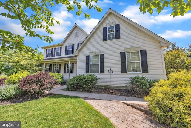 traditional-style house with a front lawn