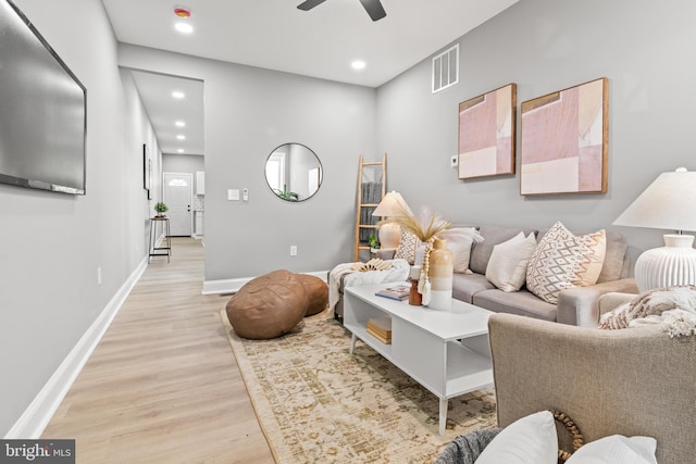living room featuring light wood finished floors, a ceiling fan, baseboards, recessed lighting, and visible vents