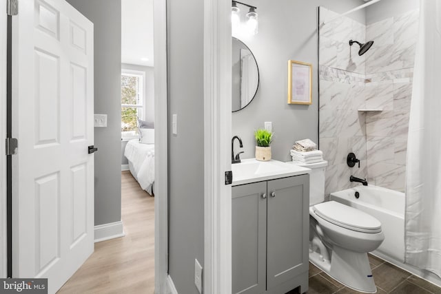 full bathroom featuring wood finished floors, vanity, toilet, connected bathroom, and shower / tub combo with curtain