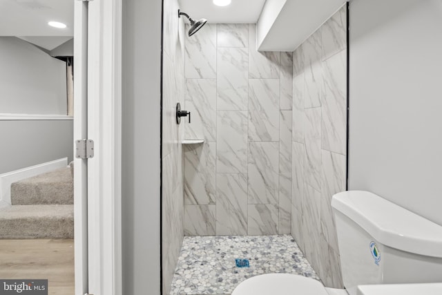 bathroom with toilet and a stall shower