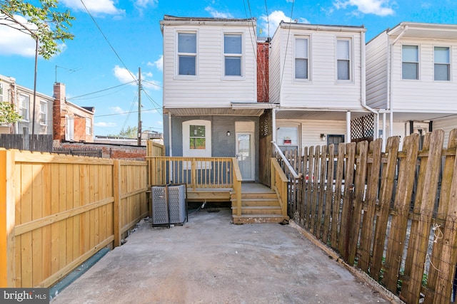 view of front of house featuring central AC and a fenced backyard