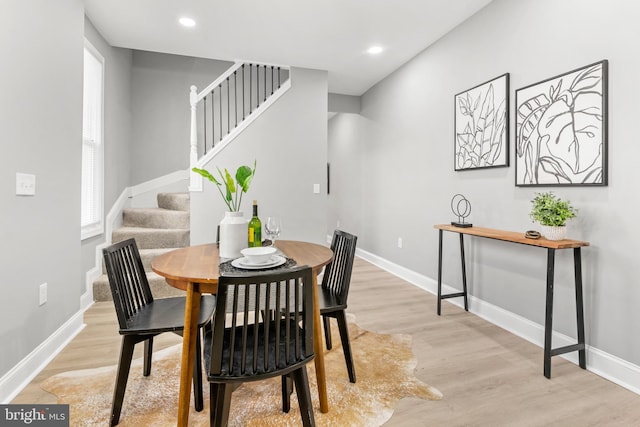 dining room with stairway, baseboards, recessed lighting, and light wood-style flooring