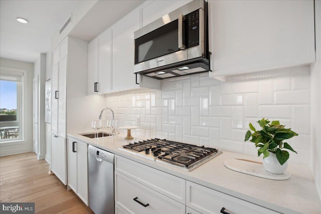 923 V St NW Unit 601, Washington, DC 20001 - kitchen featuring stainless steel appliances, white cabinets, and light countertops