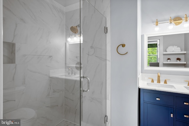 full bathroom featuring a marble finish shower and vanity