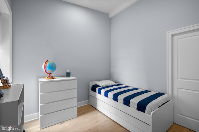 bedroom with wood finished floors and baseboards