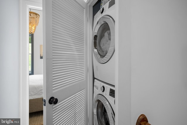 laundry area featuring stacked washer / drying machine