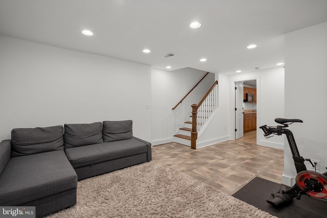 living area with stairway, recessed lighting, and baseboards