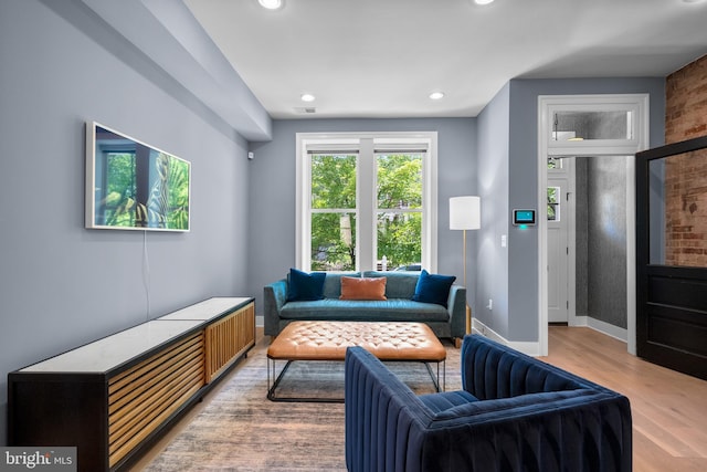 sitting room with light wood-style flooring, recessed lighting, and baseboards