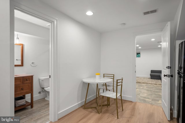 dining room featuring baseboards, light wood-style floors, and recessed lighting