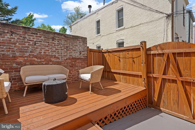 wooden deck featuring a gate and fence