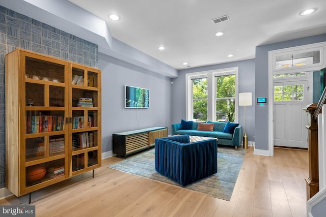 sitting room featuring baseboards, light wood-style floors, and recessed lighting