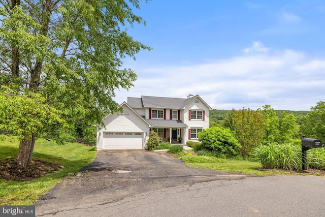 5722 Pond View Ln, Broad Run, VA 20137 - traditional-style home featuring driveway, a front lawn, covered porch, and an attached garage