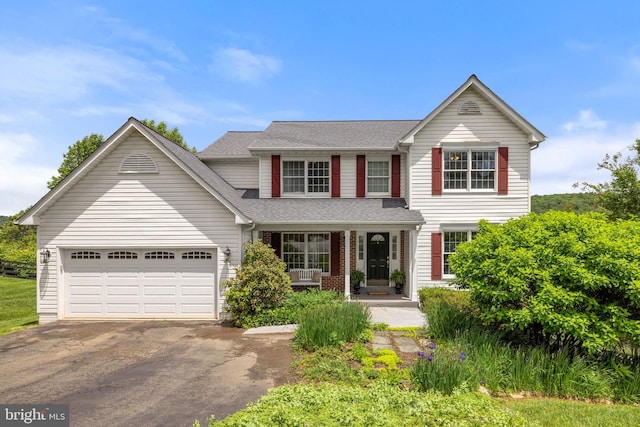 5722 Pond View Ln, Broad Run, VA 20137 - traditional-style home featuring a porch, driveway, an attached garage, and roof with shingles