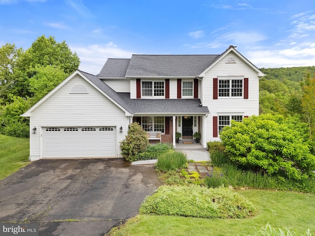 5722 Pond View Ln, Broad Run, VA 20137 - traditional-style home featuring driveway, covered porch, roof with shingles, and an attached garage