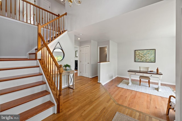 5722 Pond View Ln, Broad Run, VA 20137 - stairs with wood finished floors, baseboards, and a chandelier