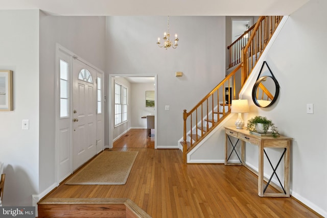 5722 Pond View Ln, Broad Run, VA 20137 - entryway featuring wood-type flooring, stairs, baseboards, a chandelier, and a towering ceiling