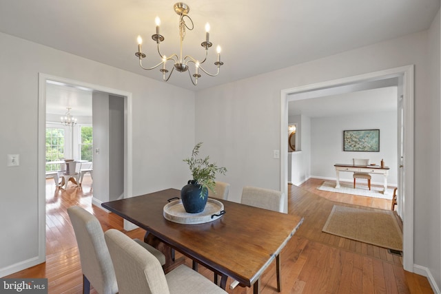 5722 Pond View Ln, Broad Run, VA 20137 - dining area featuring a chandelier, wood-type flooring, and baseboards