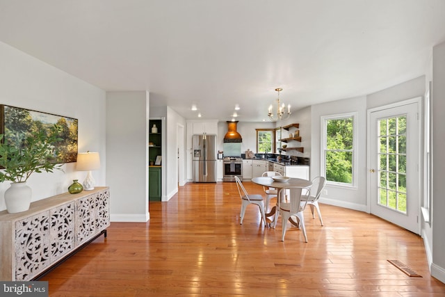 5722 Pond View Ln, Broad Run, VA 20137 - dining space featuring a chandelier, baseboards, and light wood finished floors